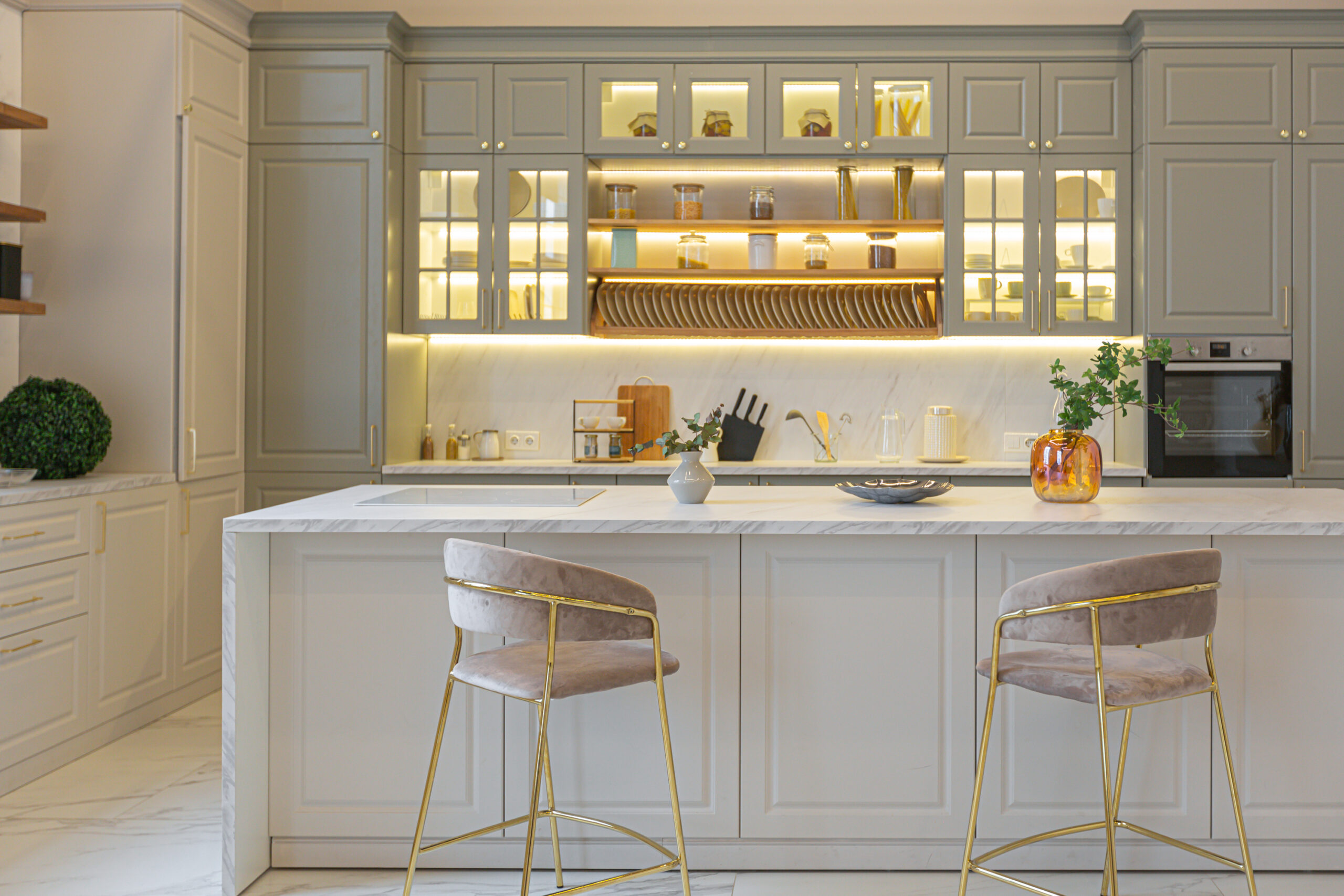 the latest fashion home trends in an ultra modern elegant interior of a cozy studio in soft pastel colors. close-ups of a stylish kitchen with an island for cooking