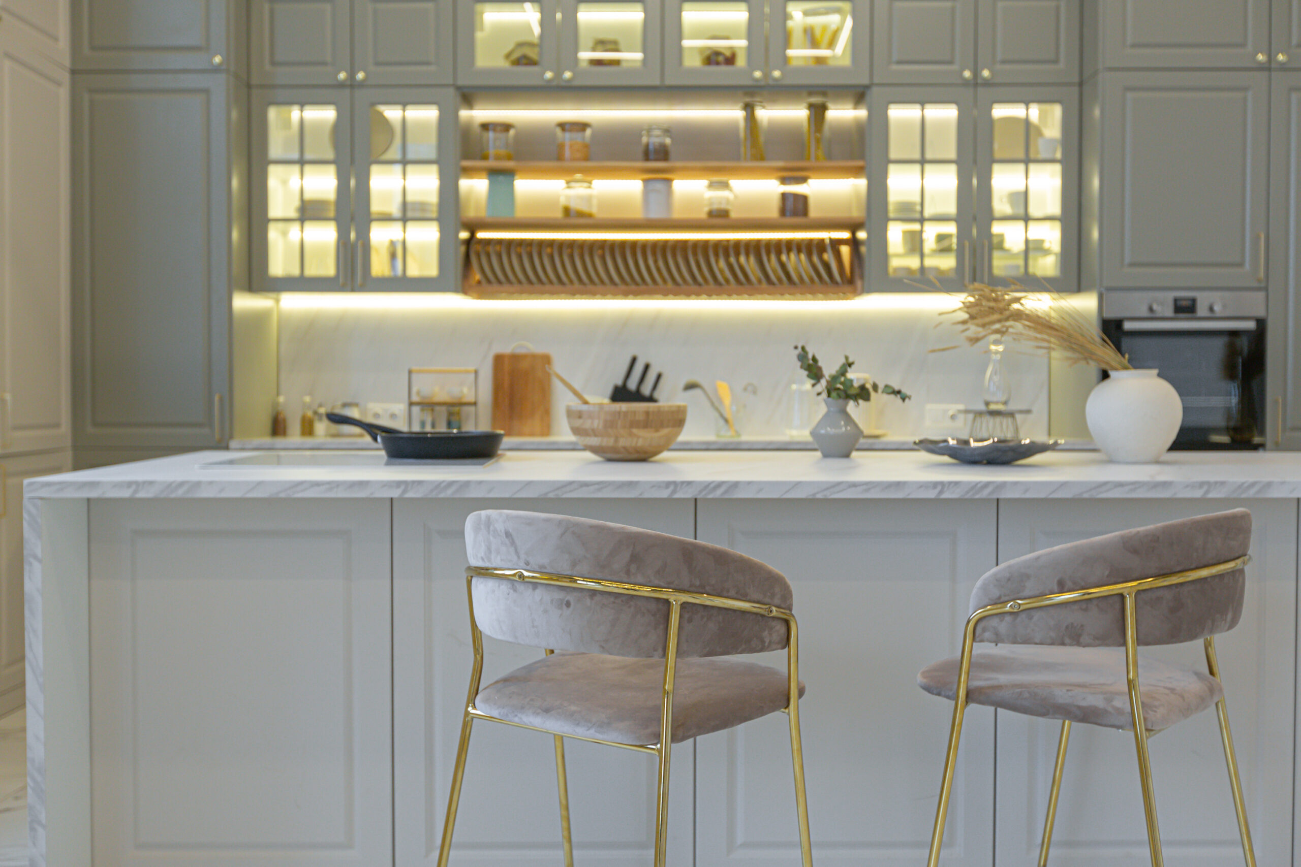 the latest fashion home trends in an ultra modern elegant interior of a cozy studio in soft pastel colors. close-ups of a stylish kitchen with an island for cooking